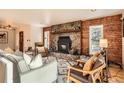 Inviting living room with stone fireplace, hardwood floors, and stylish furnishings for a comfortable space at 10439 Christopher Dr, Conifer, CO 80433