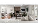 Cozy living room featuring a stone fireplace, plush seating, and ample natural light, creating a warm atmosphere at 403 S Niagara St, Denver, CO 80224