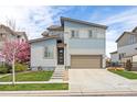 Inviting two-story home featuring a modern design, well-maintained lawn, and an attached garage at 11048 Rifle Ct, Commerce City, CO 80022