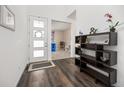 Bright foyer with wood floors, modern shelving, and access to playroom at 11048 Rifle Ct, Commerce City, CO 80022
