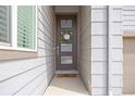 Close-up of a stylish front door with glass panels and a welcoming wreath at 11048 Rifle Ct, Commerce City, CO 80022