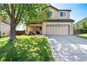 Charming two-story home features a covered porch with seating and a well-manicured lawn at 4963 Collingswood Dr, Highlands Ranch, CO 80130