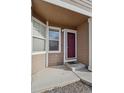A closer look at the entrance, showcasing the front door, small porch, and exterior details at 13271 Holly St # D, Thornton, CO 80241