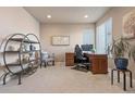 Bright office featuring a traditional wooden desk and shelving with ample natural light and cozy decor at 18926 W 93Rd Ave, Arvada, CO 80007