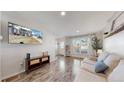 Bright and open living room with hardwood floors, lots of natural light, and neutral paint at 12426 W Temple Dr, Morrison, CO 80465