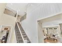 Elegant foyer featuring soaring ceilings, a staircase with iron railings, and an open view to the living room at 631 Felicity Loop, Castle Rock, CO 80109