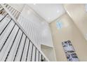 Bright foyer showcasing high ceilings, a staircase with decorative iron railings, and modern architectural details at 631 Felicity Loop, Castle Rock, CO 80109