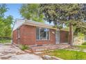Well-maintained brick house featuring a large picture window and a welcoming front entrance at 4624 W Virginia Ave, Denver, CO 80219