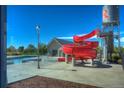 Fun community pool with a winding red slide next to a water tower feature at 10451 Truckee St # 2D, Commerce City, CO 80022