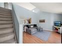 Bright living room with vaulted ceiling, cozy gray sectional, and view into the adjacent kitchen at 7977 Emerson Ave, Frederick, CO 80530