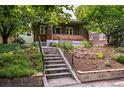 Charming brick home featuring concrete stairs and vibrant greenery, enhancing curb appeal at 3321 Stuart St, Denver, CO 80212