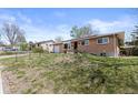 Beautiful brick home with a well-manicured lawn, offering great curb appeal at 4102 W Eastman Ave, Denver, CO 80236