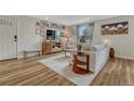 Bright living room features stylish furniture, wood-look flooring, neutral color palette, and decorative accents at 9401 Otis St, Broomfield, CO 80021