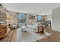 Cozy living room with stylish furniture, decor, wood-look flooring and plenty of natural light at 9401 Otis St, Broomfield, CO 80021