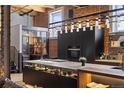 Modern kitchen with large island, stainless steel appliances, brick wall, and custom lighting at 1792 Wynkoop St # 505, Denver, CO 80202