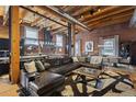Open-concept living space with hardwood floors, exposed brick, and stylish furnishings at 1792 Wynkoop St # 505, Denver, CO 80202
