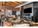 Comfortable living room with a large sectional sofa, media center, and exposed brick walls at 1792 Wynkoop St # 505, Denver, CO 80202