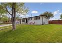 Attractive home featuring a well-groomed lawn and a cozy front porch with seating at 45 S Reed St, Lakewood, CO 80226