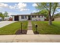 Beautiful home with a well-maintained lawn and a walkway leading to the inviting front entrance at 45 S Reed St, Lakewood, CO 80226