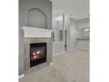 Cozy living room featuring a tiled fireplace with a decorative white mantel at 7131 S Wenatchee Way # C, Aurora, CO 80016