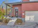 Attractive front entrance featuring a stylish black door with decorative wreath, sidelight window, and attached garage at 2514 Sweet Wind Ave, Castle Rock, CO 80109