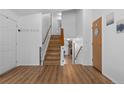 Spacious entryway with wood-look floors and staircase leading to a lower level at 455 Saddlewood Cir, Highlands Ranch, CO 80126