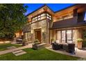 Beautiful stone home featuring an outdoor seating area and manicured lawn at 467 Saint Paul St, Denver, CO 80206