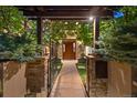 Inviting walkway leading to the front door, framed by lush greenery and stone pillars at 467 Saint Paul St, Denver, CO 80206