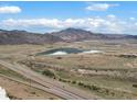 Picturesque aerial view showcasing the property's proximity to a tranquil lake and highway access at 4226 S Eldridge St # 207, Morrison, CO 80465