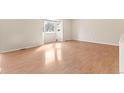 Bright living room with gleaming hardwood floors and a large bay window at 3355 S Emerson St, Englewood, CO 80113
