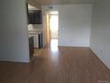 A spacious living room with laminate flooring extends to other rooms including the kitchen in the background at 10772 E Exposition Ave Ave # 342, Aurora, CO 80012