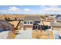 Bright and airy aerial view of a 2-story home in an open field, complete with a three-car garage at 15507 Quince Cir, Thornton, CO 80602