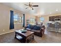 Open concept living room with a large window and stylish furniture at 15507 Quince Cir, Thornton, CO 80602