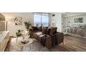 Staged living room with contemporary furnishings, hardwood floors, and views from the balcony at 601 W 11Th Ave # 815, Denver, CO 80204