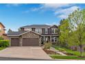 Attractive two-story house showcasing a well-manicured lawn and stone accents on the facade at 24682 E Ontario Dr, Aurora, CO 80016