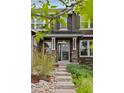 Inviting home entrance with stone accents, manicured shrubs, and an address marker at 24682 E Ontario Dr, Aurora, CO 80016