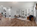 Cozy living room featuring wood floors, built-in shelving, and a fireplace at 24682 E Ontario Dr, Aurora, CO 80016
