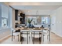 Modern dining area with wood table and seating for six at 16551 Peak Way, Broomfield, CO 80023