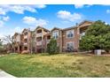 Condominium buildings showcasing balconies, stone accents, and vibrant green lawns at 7440 S Blackhawk St # 16-208, Englewood, CO 80112