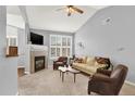 Cozy living room with fireplace, vaulted ceiling, and neutral-toned furniture at 7440 S Blackhawk St # 16-208, Englewood, CO 80112