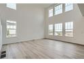 Bright, airy living room featuring high ceilings and lots of natural light at 98 Wooten Ave, Brighton, CO 80601