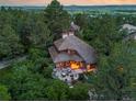 An aerial view of a gorgeous home nestled in lush greenery with a unique roof design and picturesque setting at 4406 Orofino Pl, Castle Rock, CO 80108
