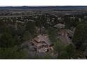 A high angle aerial view of a neighborhood offering beautiful rooftops amongst mature tree coverage at 4406 Orofino Pl, Castle Rock, CO 80108