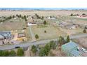 Wide aerial shot showing a community, several homes, and a spacious, grassy lot at 12337 2Nd St, Parker, CO 80134