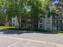 A multi-story apartment building with lush trees and a well-maintained lawn at 7346 S Xenia Cir # A, Centennial, CO 80112