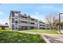 Exterior view of multi-story home featuring large balconies and manicured lawn at 7346 S Xenia Cir # A, Centennial, CO 80112
