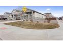 A view of a single-Gathering home on a corner lot, showing the sidewalk and lawn area at 968 Honey Berry Ct, Elizabeth, CO 80107