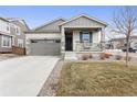 Charming single-Gathering home with a well-manicured lawn, covered porch, and attached two-car garage at 968 Honey Berry Ct, Elizabeth, CO 80107