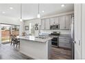 Modern kitchen features stainless steel appliances, granite countertops, and a central island with a sink at 968 Honey Berry Ct, Elizabeth, CO 80107