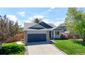 Attractive home featuring a landscaped lawn and a convenient two-car garage at 11560 River Run Cir, Commerce City, CO 80640